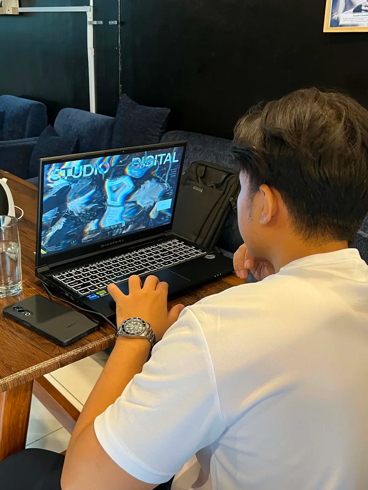 Laptop open on a work-in-progress site at a café table